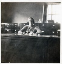 Bernice Smith sitting at a desk in the Picture Room of the Bridgeport Public Library