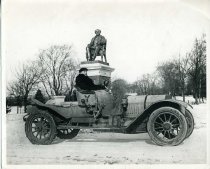 William Buckley in a Locomobile car in Seaside Park in front of the P.T. Barnum statue