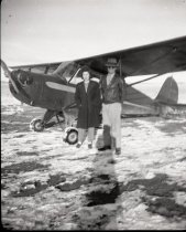 Man & Woman in front of airplane