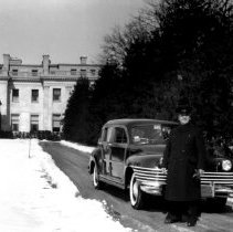 Chauffeur in front of Woolworth Estate