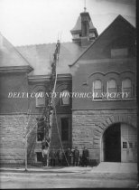 Escanaba Fire Department on Ladder by City hall