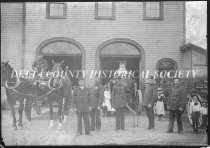 Escanaba firemen in font of old fire station