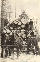 Five lumbermen and loaded sled