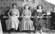 Three young women on seated on couch