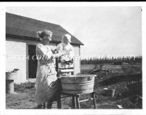 Mother and baby with wash tub