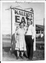 Edith and Emil Kallio in front of sign