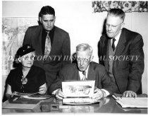 Delta County Historical Society Board Members examine an album