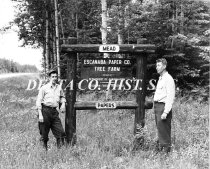 Bill Howe and Bob Schmeling by tree farm sign, 1949