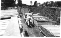 Crew loading lumber onto wagon