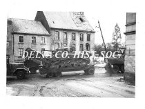 American Army WW II vehicles moving through a Euopean city