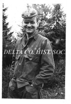 American GI (Marcoe) posing with German helmet