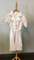 White dress with red trim and large red buttons