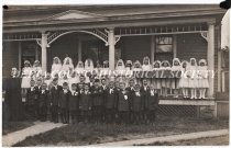 Father Owen Bennett and group of children on rectory steps