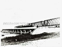 Concrete highway bridge over Escanaba River, RR brigde in background