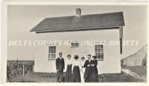 Family in front of an early farm house on Stonington