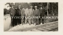 Group of men inspecting railroad tacks