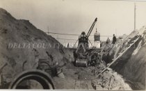 Steamshovel digging large trench for City sewer