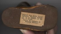 Label from bronzed baby shoes