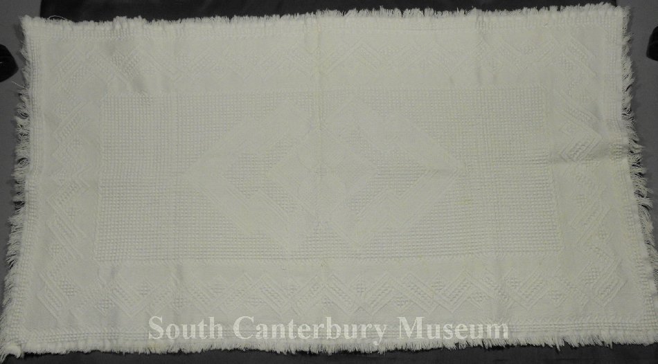 Blanket White cotton cot blanket. The blanket is a rectangle and has