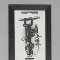 Print of an Ingersoll-Rand jackhammer, black wood frame; c.1912