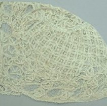 Beige, tatted lace baby cap, pattern made up of flower designs.