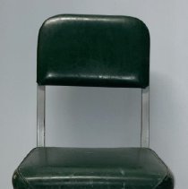 Chair with grey metal frame and green vinyl seat and back.
