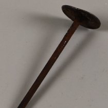 Nail with silver dollar head, from Country Kitchen floor; unknown date.