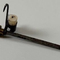 Miner's candlestick with small stub of candle.