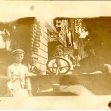 Paper carrier next to a car.