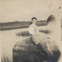 Woman sitting on a rock