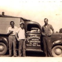 3 men near Columbia Meat & grogeries truck