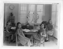 Girl Scouts reading at the table