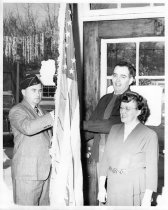 Ethel Barnum accepting a flag for the library