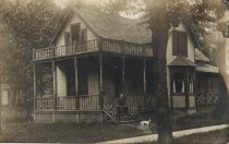A man sitting on the steps of a front porch