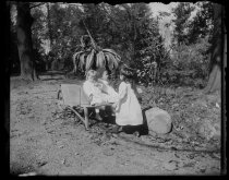 Little Parmeles and A. Alburger in wheelbarrow, by Alice Austen, 1890