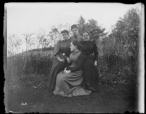 The Darned Club in a chair, photo by Alice Austen, October 29, 1891