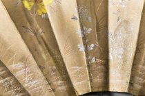 detail of front, two frogs, one holding a flower