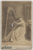 Portrait of Maud Morgan with a harp, photo by Falk, ca. 1875-1885