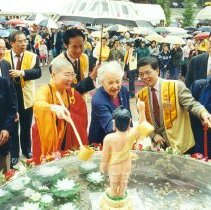 Mayor McCallion pouring holy water on Buddha at Fo Guang Shan Buddhist temple