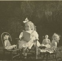 Little Girl Reading to Her Dolls, Book Up