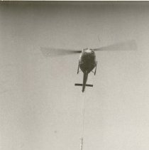 Helicopter transporting utility pole