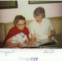 Margaret & Lois looking at photo album