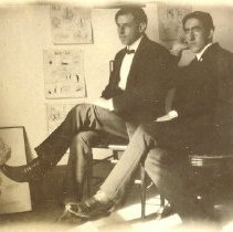 Unknown men sitting in chairs