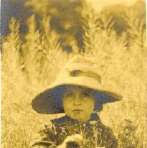 Among Wild-Flowers. Child in field with hat .  1909