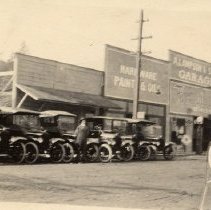 Cars in Front of Lampson Tractor on Main Street