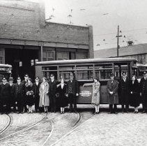 Group standing in front of electric streetcar