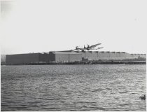 Boeing B-29 in flight, taking off over Lake Washington, WA, 8 x 10" black a