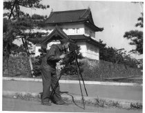 Bob Hall with a movie camera on a tripod.