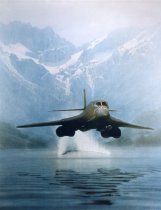 B-1B aircraft kicking up "rooster tail" due to aircraft vortex