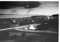 Quonset huts at night, probably Saipan.